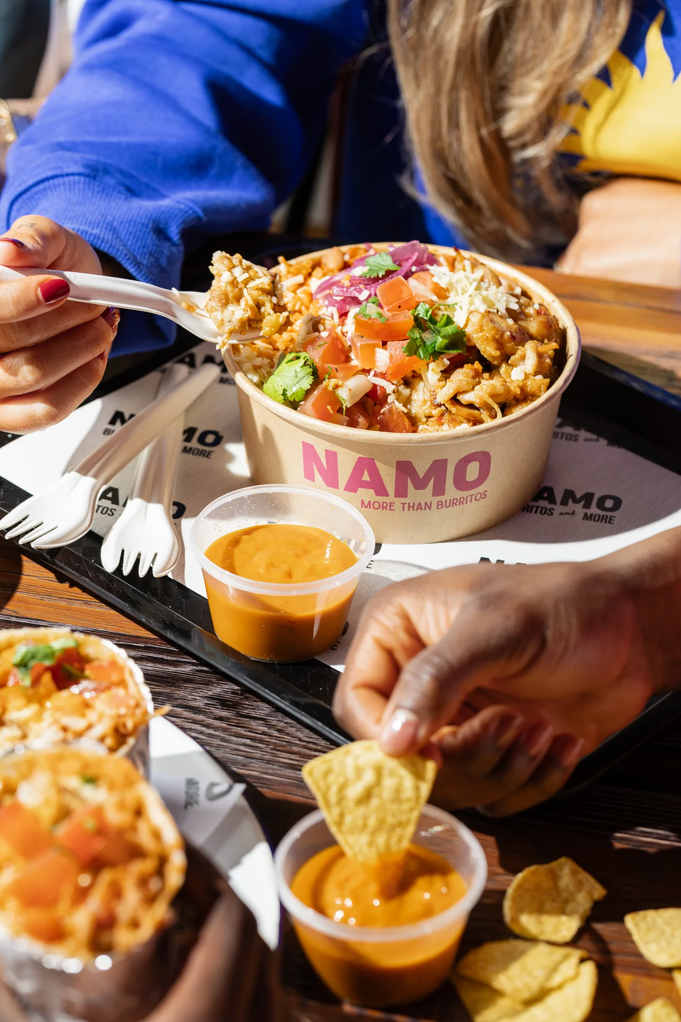 NAMO burrito bowl being enjoyed with tortilla chips and dips